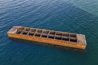 France, Calvados, Arromanches les Bains, cliffs of Cap Manvieux, Mulberry B remains, Port Winston, Phoenix breakwaters (aerial view)