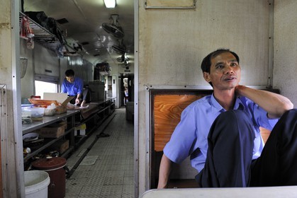 Vietnam, day train from Lao Cai to Hanoi, the restaurant carriage and the kitchen in the back