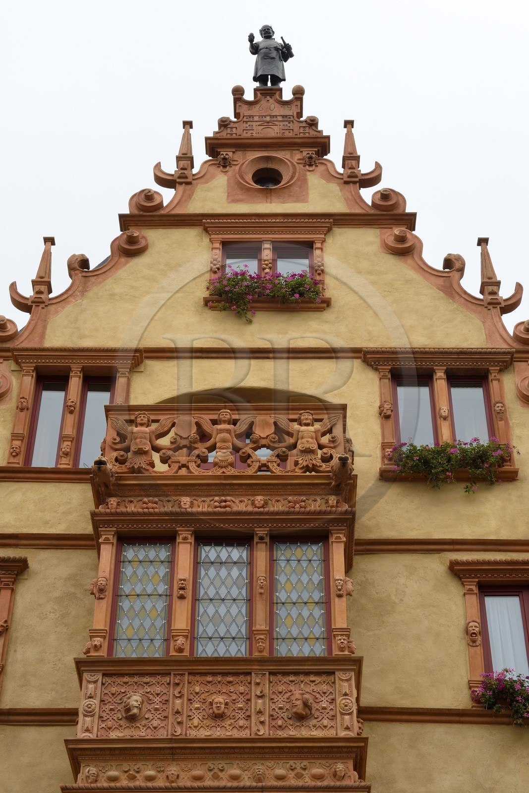 France, Haut Rhin, Colmar, la Maison des Tetes, renaissance style (1609), formerly a wine seller, the tin statue The Alsatian Cooper by Auguste Bartholdi was installed in 1902 at the top of the pinion