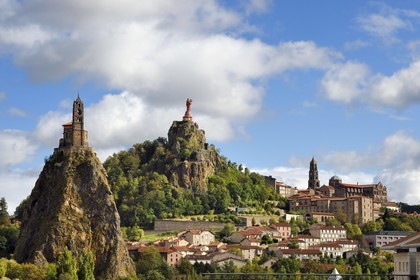 France, Haute Loire, Le Puy en Velay, Routes of Santiago de Compostela in France listed as World heritage by UNESCO, view of the city with the Saint-Michel d'Aiguilhe Chapel perched on a volcanic peak on the left, the Notre Dame de France statue (from 1860) on the Rocher Corneille overlooking the 12th century Notre Dame de l'Annonnement cathedral on the right