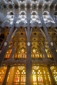 Spain, Catalonia, Barcelona, Eixample district, Sagrada Familia basilica by Catalan modernist architect Antoni Gaudi, listed as a UNESCO World Heritage Site, the facade side of the Passion of the Nave with its warm-colored stained glass windows and the vault at the top