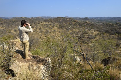 Zimbabwe, Matabeleland South Province, Matobo or Matopos Hills National Park, listed as World Heritage by UNESCO, walking safari in search of White Rhinoceros, looking through binoculars