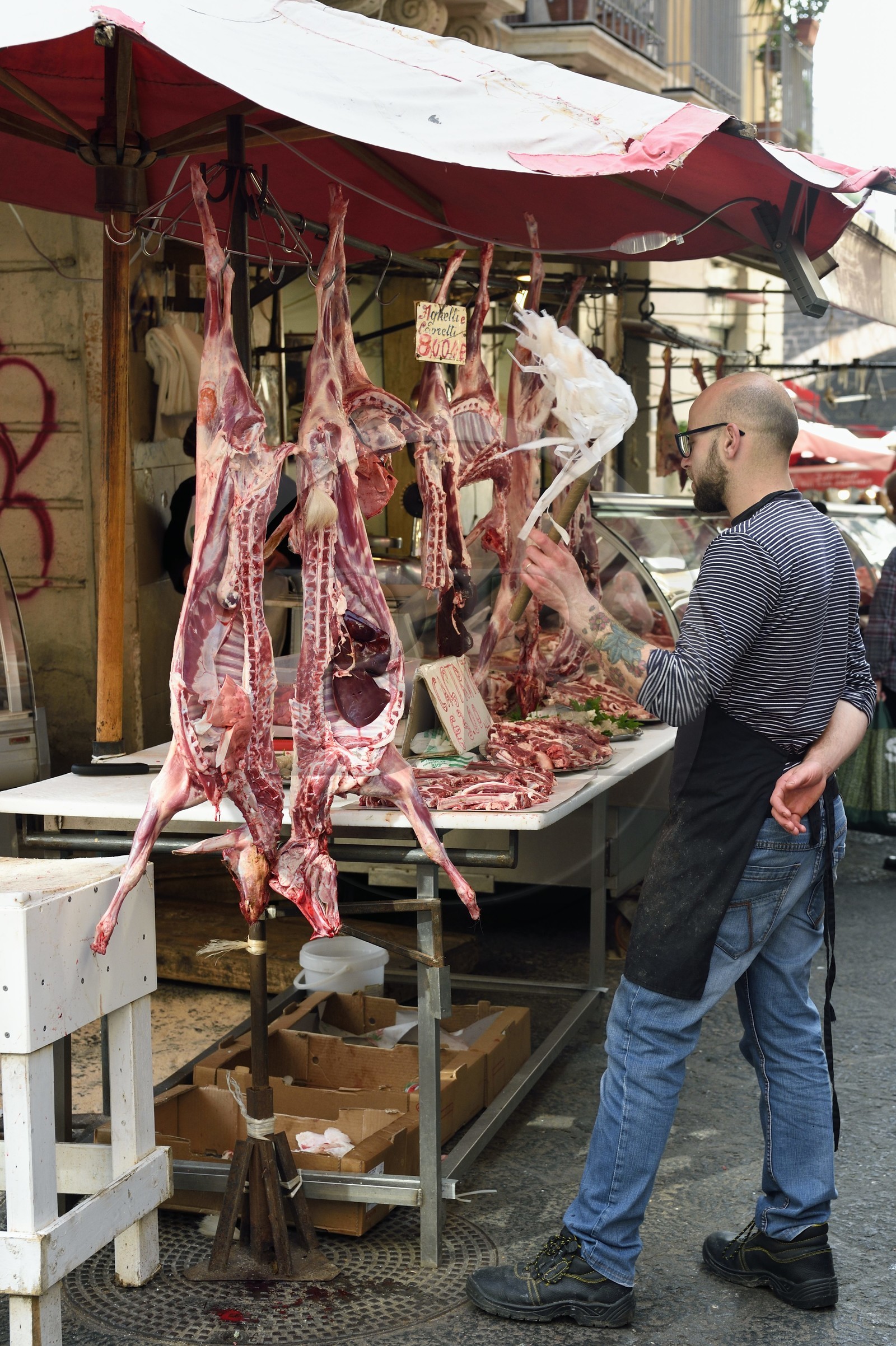 Italy, Sicily, Catania, Baroque city listed as UNESCO World Heritage, the Pescheria morning market in the Duomo district, meat sale