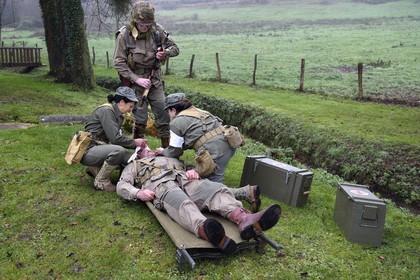 France, Eure, Sainte Colombe prés Vernon, Allied Reconstitution Group (US World War 2 and french Maquis historical reconstruction Association), reenactors in uniform of the 101st US Airborne Division and nurses caring for a wounded soldier