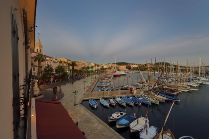 France, Var, Sanary-sur-Mer, traditional fishing boats called pointus in the port and St. Nazaire Church