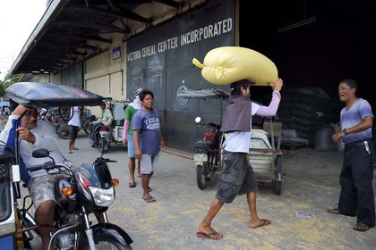 Philippines, province of Tarlac, Victoria, cereals delivery on a tricycle motorcycle taxi