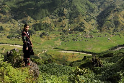 Vietnam, Lao Cai province, Sapa district, young woman from the Black Hmong minority group overlooking her valley Hau Thao