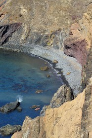 Portugal, Madeira Island, hike in the Ponta de Sao Lourenço nature reserve in the far east of the island, kayak going away from the pebble beach