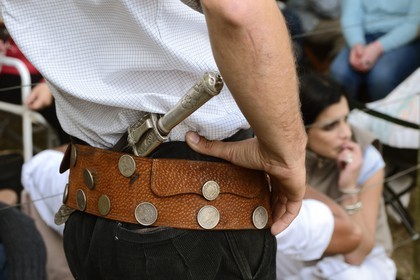 Argentina, Buenos Aires Province, San Antonio de Areco, Tradition Day festival (Dia de Tradicion) close up at a gaucho's traditional belt and the facon (wide and long knife)