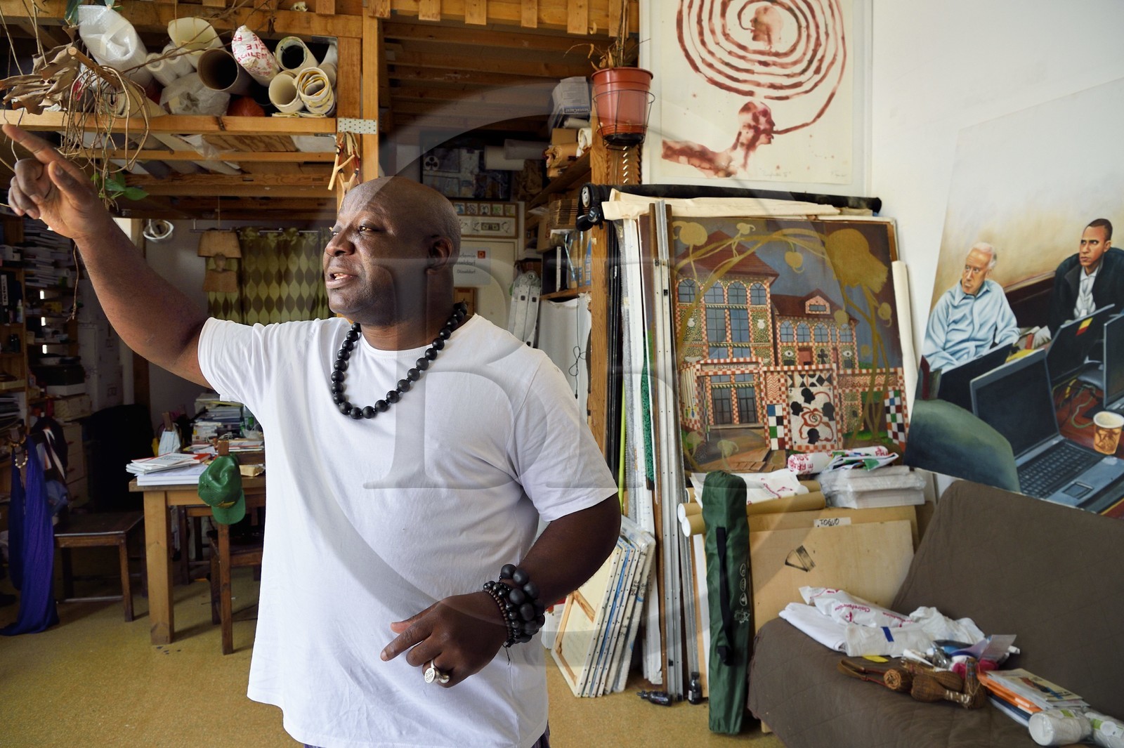 France, Paris (75), Barthelemy Toguo, l'artiste fondateur de Bandjoun Station au Cameroun (représenté dans la peinture en arrière plan), dans son atelier parisien