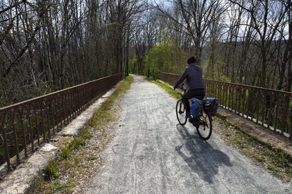 France, Dordogne, Périgord Vert, Saint Jean de Cole labelled Les Plus Beaux Villages de France (The Most Beautiful Villages of France), cyclist on the green lane of the Flow Vélo cycle route which follows the old railway line