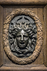 France, Paris, Marais district, Carnavalet Museum, bronze Medusa heads medallion on the door of the town hall