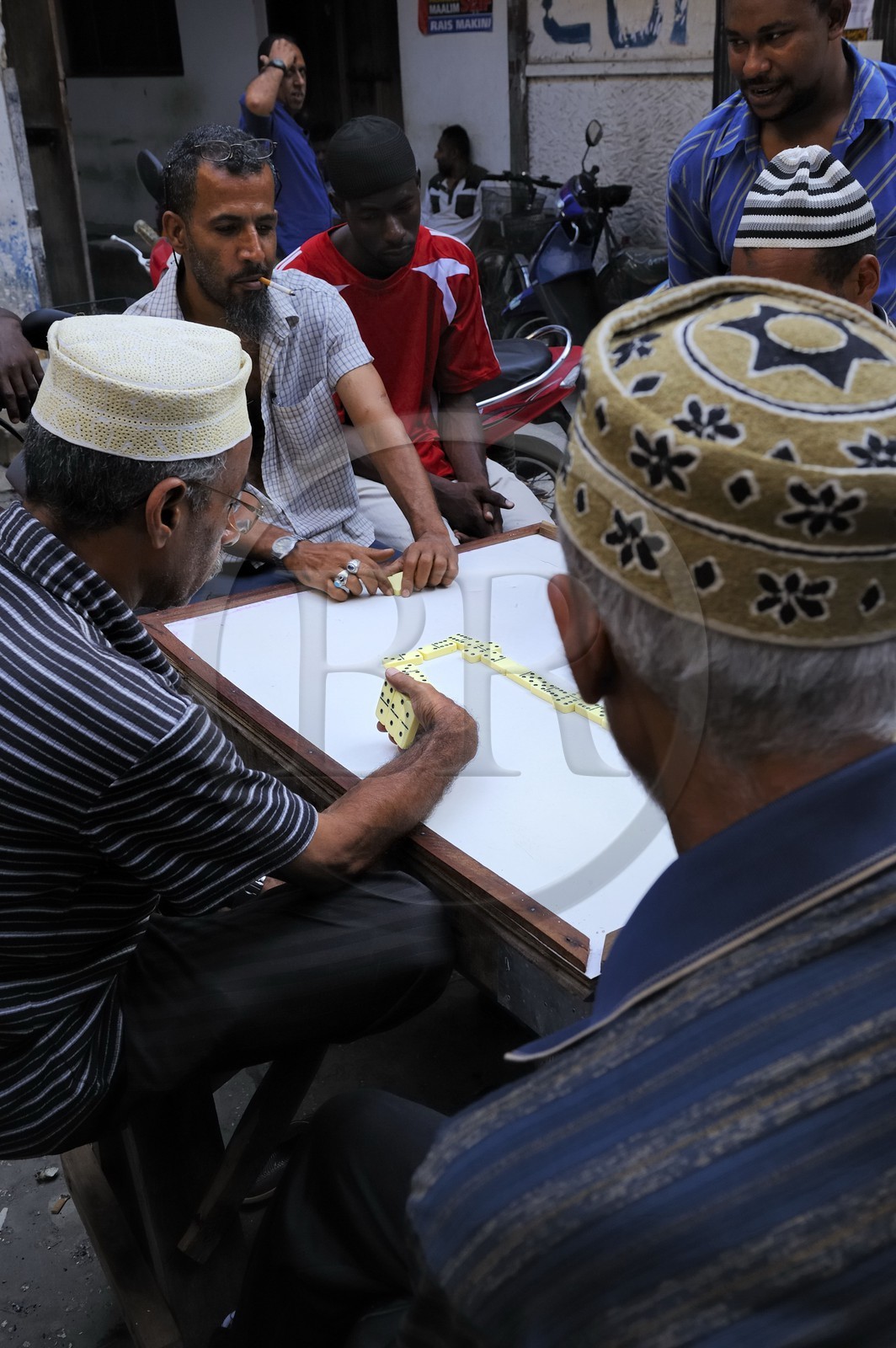 Tanzania, Zanzibar Archipelago, Unguja island (Zanzibar), Stone Town, listed as World Heritage by UNESCO, domino players in a street from the old city in the Shangani neighborhood