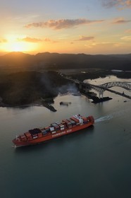 Panama, Panama City, Panama Canal entrance on the Pacific Ocean side, a Panamax container cargo passing under the Bridge of the Americas (Puente de las Americas) (aerial view)