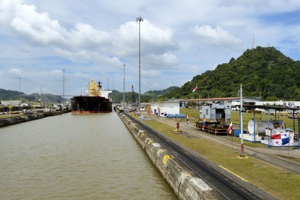 Panama, Panama Canal, Pedro Miguel locks, mechanical mules or electric locomotives guiding a Panamax cargo between the lock walls