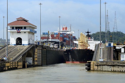 Panama, Panama Canal, Pedro Miguel locks, mechanical mules or electric locomotives guiding a Panamax cargo between the lock walls