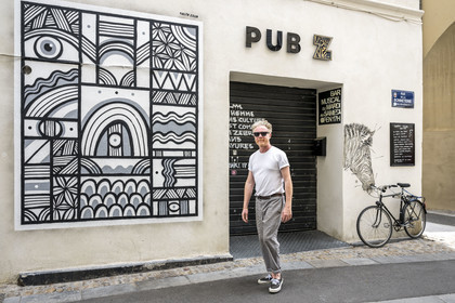 France, Vaucluse, Avignon, the graffiti artist Pablito Zago in front of the Pub Z whose mural he painted, founder of the Cartel association and the Shed workshop