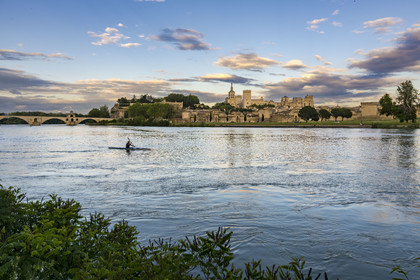 France, Vaucluse, Avignon, kayak passing on the Rhone in front of the Doms Cathedral and the Palais des Papes (Palace of the Popes) listed as World heritage by UNESCO