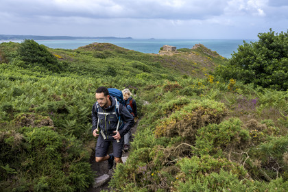 France, Cotes d'Armor, Grand Site de France Cap d'Erquy – Cap Frehel, Erquy, hikers on the GR34 hiking trail or coastal trail with the heated shot in the background