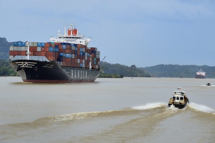 Panama, Panama Canal at Gamboa, Korean Panamax container cargo and pilote boat