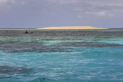 France, Mayotte island (French overseas department), Grande-Terre, M'Tsamoudou, islet of white sand on the coral reef in the lagoon facing Saziley Point, fisherman in dugout