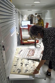 France, Charente, Angouleme, Cité internationale de la bande dessinée et de l’image (CIBDI)(International city of comics and images), in the reserves of the comic museum, Caroline Janvier researching the collections