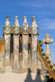 Spain, Catalonia, Barcelona, Eixample district, Passeig de Gracia, Casa Batllo by Catalan modernist architect Antoni Gaudi, UNESCO World Heritage site, chimneys, roof suggesting a dragon's spine and tower crowned with a ceramic spire surmounted by a typical Gaudi cross