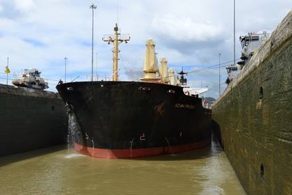 Panama, Panama Canal, Pedro Miguel locks, mechanical mules or electric locomotives guiding a Panamax cargo between the lock walls