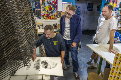 France, Vaucluse, Avignon, Turboformat workshop, artist Ben Sanair on the right in his workshop with artist Lionel Vivier checking his screen printing under the gaze of Stéphane Ibars, artistic director of the Lambert Collection