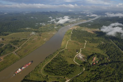 Panama, Panama Canal, a Panamax container cargo uses the Gaillard cut (or Culebra cut) between the Pedro Miguel locks on the Pacific side and the Chagres river leading to Gatun Lake (aerial view)