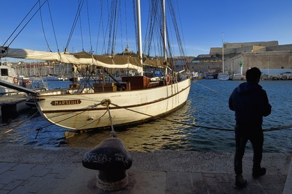 France, Bouches du Rhone, Marseille, the Vieux Port, the Marseille sailboat and Notre Dame de la Garde in the background