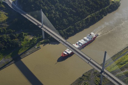 Panama, Panama Canal, a Panamax container  cargo and the Centennal bridge (puente Centenario) spanning the Canal (aerial view)