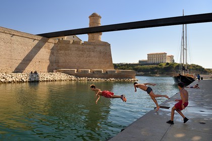 France, Bouches du Rhone, Marseille, La Joliette district, swimming area for neighborhood children at the foot of Fort Saint Jean linked to the MuCEM (Museum of Civilizations of Europe and the Mediterranean) by a bridge, Palais du Pharo in the background
