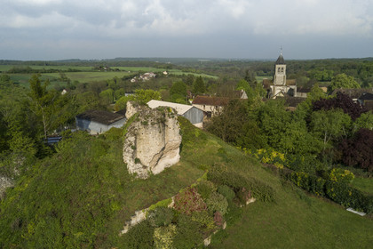 France, Yvelines, Montchauvet, ruins of the castle dungeon built in 1136 by Amaury de Montfort and Sainte Marie Madeleine (St. Mary Magdalene) church in the background