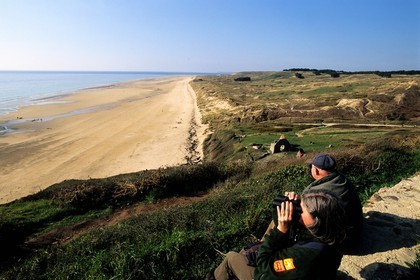 France, Manche, Cotentin, Barneville Carteret, walkers observing the beach of the vieille eglise (old church) and the dunes