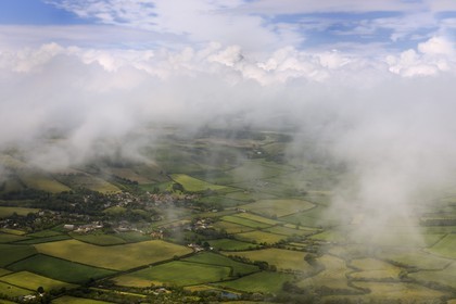 United Kingdom, England, Dorset, the village of Litton Cheney in the clouds surrounded by fields (aerial view)