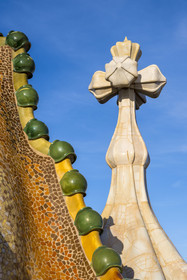 Spain, Catalonia, Barcelona, Eixample district, Passeig de Gracia, Casa Batllo by Catalan modernist architect Antoni Gaudi, UNESCO World Heritage site, roof suggesting the spine of the dragon and tower crowned with a ceramic spire topped with a typical Gaudi cross