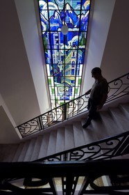 France, Alpes de Haute Provence, Ubaye valley, Barcelonnette, mexican villa known as the Blue Villa,  8.10 m high stained glass created in 1933 by master glassmaker Gruber of the Nancy School representing looms sheets, smoking chimneys of textile factories and a department store, it celebrates the success in Mexico of its first owner Camille Jean founder of the Francia Maritima department store