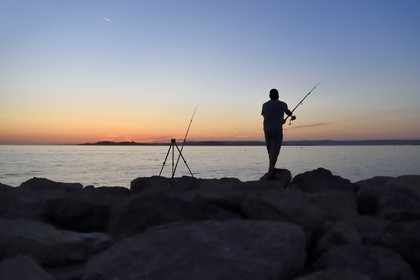 France, Bouches du Rhone, Marseille, La Madrague, fisherman at the sunset facing the Frioul