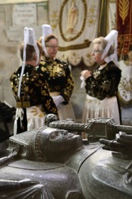 France, Finistere, Locronan, labelled Les plus Beaux Villages de France (The Most Beautiful Villages of France), women in traditional costume during the Tromenie around the cenotaph of St Ronan in Peniti chapel adjacent to the Saint Ronan church