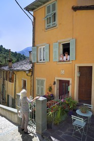 France, Alpes-Maritimes, Roya Valley (Nice hinterland), at the foot of the Mercantour National Park, Saorge, two inhabitants of the village in discussion with Mrs. Bresque, Mayor of Saorge