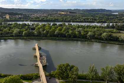 France, Vaucluse, Avignon, the Saint-Bénézet bridge (Avignon bridge) and the Ile de la Barthelasse between the two arms of the Rhone river, the Philippe-le-Bel Tower and the Fort Saint-André in Villeneuve-lès-Avignon in the background (aerial view)
