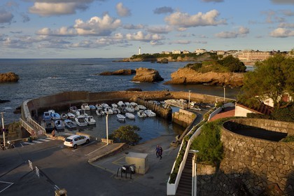 France, Pyrenees Atlantiques, Basque Country, Biarritz, Port des Pecheurs, the lighthouse and the Hotel du Palais located on Grande Plage (Great beach) in the background