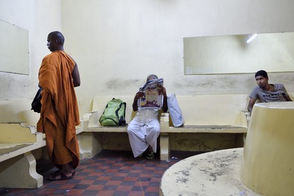 Sri Lanka, Colombo, central Colombo Fort train station, Buddhist monk in the waiting room
