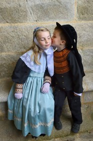 France, Finistere, Locronan, labelled Les plus Beaux Villages de France (The Most Beautiful Villages of France), kiss of children in traditional costumes under the porch of Saint Ronan church the day of the procession of the Tromenie