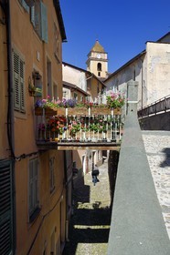 France, Alpes-Maritimes, Roya Valley (Nice hinterland), at the foot of the Mercantour National Park, Saorge, a narrow lane overhung by a pountin (small bridge) and Saint-Sauveur (St. Saviour) church