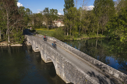 France, Charente, vibrac, the medieval elbow bridge that crosses the Charente river on the route of the Flow Vélo cycle route (aerial view)
