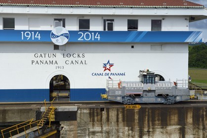 Panama, Colon province, Panama Canal, Gatun locks, mechanical mule or electric locomotive guiding the Panamax cargos between the lock walls