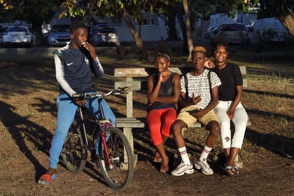 France, Mayotte island (French overseas department), Petite-Terre, Dzaoudzi, teens in discussion