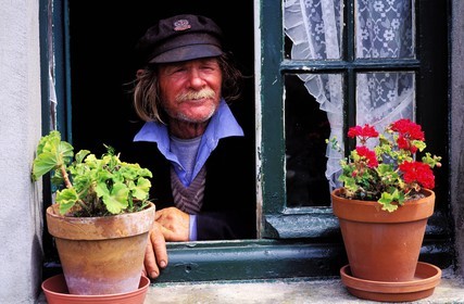 France, Manche, Iles Chausey, a former sailor by his window